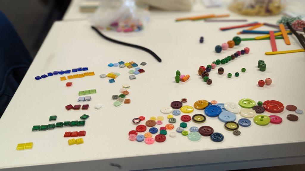Decorative image of buttons and other small objects arranged to visualise data
